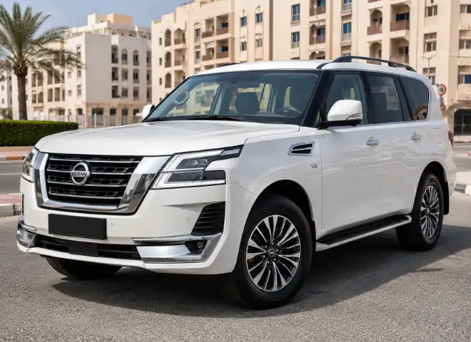 Front three-quarter view of a white Nissan SUV parked on a city street with beige residential buildings in the background.